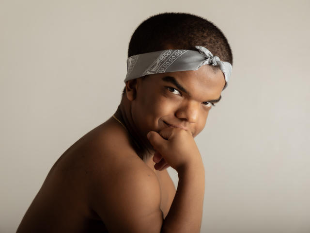 Simple, flat-style illustration of a large, dark red, and orange paper lantern with a subtle pattern. The lantern has a small, black emblem in the upper right corner.