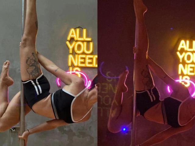 AdalineBliss69 with tattoos, black sports bra, and shorts, pole dancing, left leg raised, neon "ALL YOU NEED" sign in background, right image, dim lighting, purple neon glow.