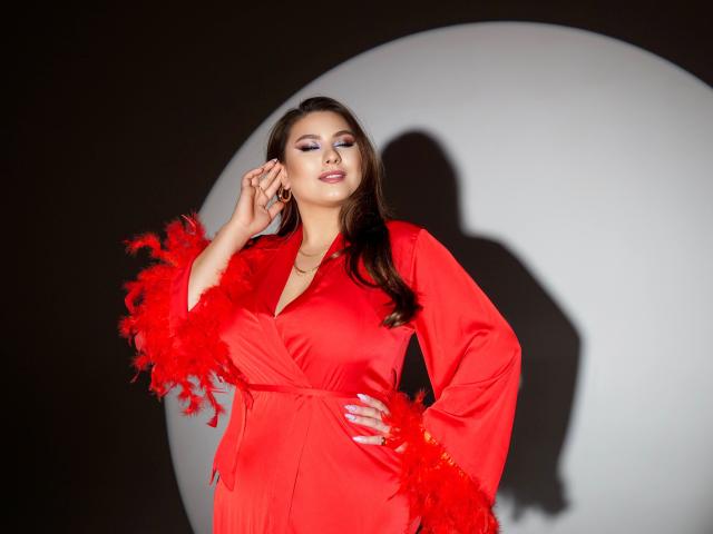 MysteriousLight in a red dress with fluffy red sleeves, hand on hip, shadow on white circle, brown hair, blue eyeshadow, confident expression, slight smile, soft light.