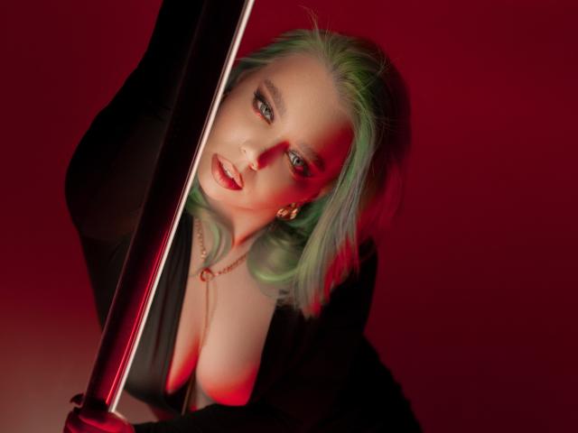 EnergyBurnny with green hair, looking at camera, holding pole, red lighting, wearing black jacket, necklace, earrings, medium tits, soft smile, looking sexy, upper body shot, seductive.