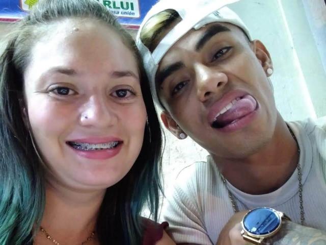 ParejaEnLlamas with black hair, small nose ring, and pink lipstick, smiling with frosted teeth. ParejaEnLlamas, male, tan, with white cap, earrings, and tongue out, holding a watch.