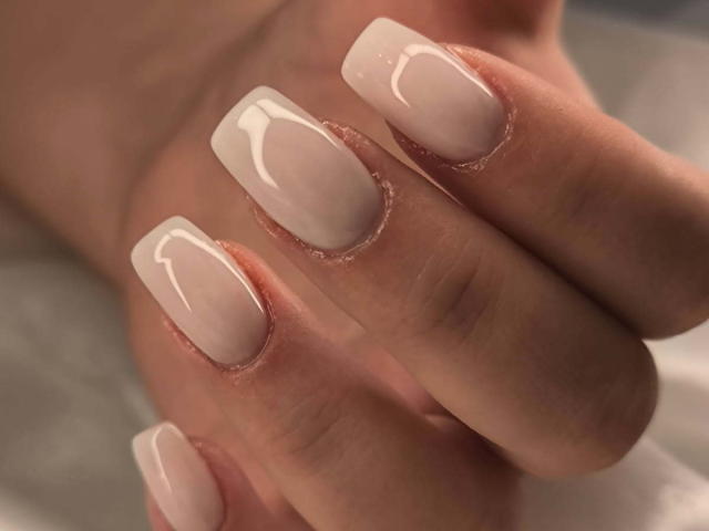 ElvinnaLaFrancaise's nails are shiny and nude with a glossy finish, showing off her perfectly manicured, square-shaped boobs. The focus is on her smooth, polished nails.
