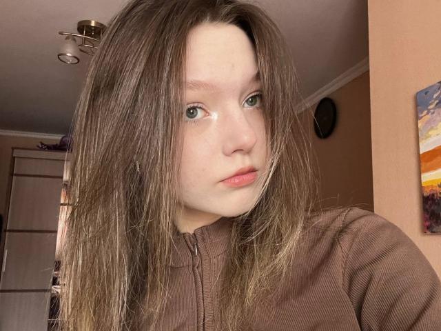 A minimalist, digital art style featuring a large, white, flat, geometric pattern with a subtle red accent in the bottom right corner. Simple, clean lines dominate the composition.