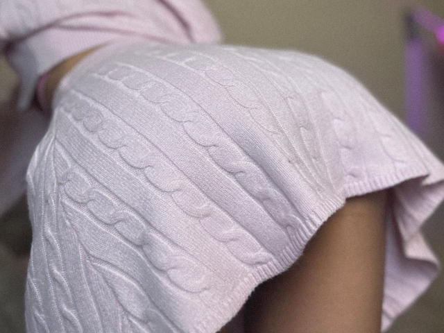 Flat, minimalist illustration of a coat of arms. Central white emblem with red borders. Simple, clean lines. No texture or shading. Bold, solid colors. Pingli's crest design.