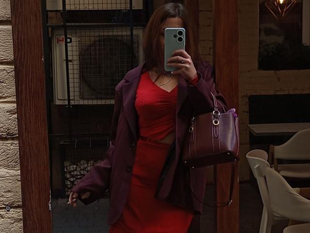 DaizyRara with red dress and purple jacket, holding phone in front of face, purple handbag, brown hair, standing in doorway, mirror selfie, showing tits and ass.