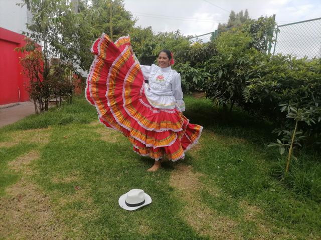 PauletteLoveX with big red and yellow plaid skirt, white blouse, and red mask, standing on grass, holding skirt up, showing her ass, with white hat on ground.