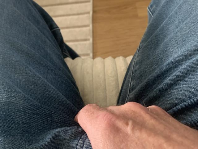 Close-up of a minimalist, stylized emblem featuring a bold, vertical red and black pattern with a central, slightly blurred, red-orange rectangle. Simple, geometric design.