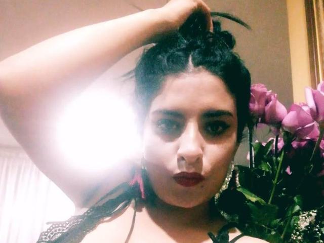 JolieeCoquineXx's wet, glossy, pink, slightly parted lips with a visible white tooth in the center, showing a glistening, moist texture.