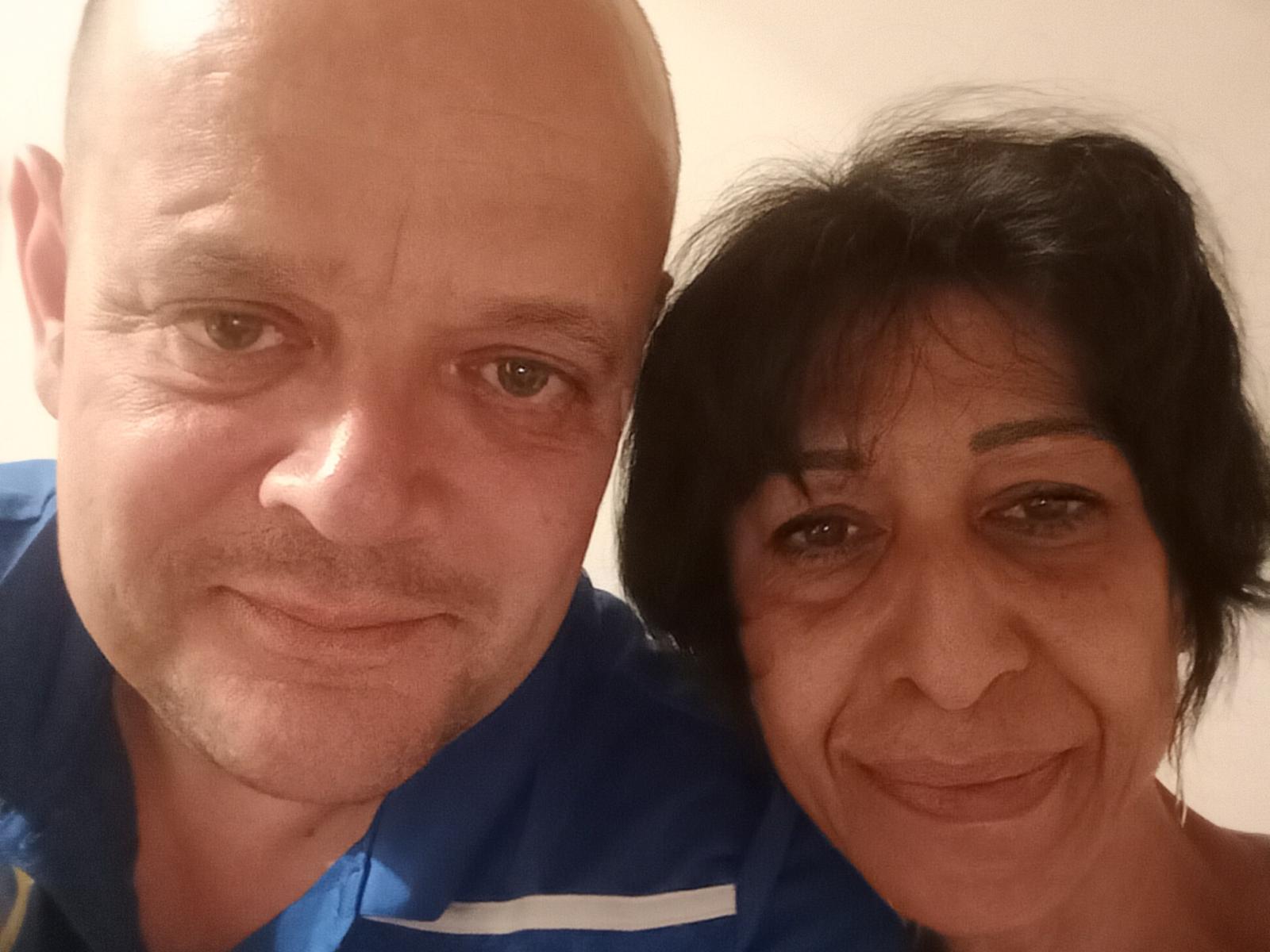 ChriStars with bald head and blue shirt, and ChriStars with short black hair and tan skin, both smiling. ChriStars' nose is slightly shiny, ChriStars' face shows light wrinkles.