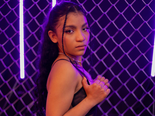 Digital illustration of a red-orange emblem with a white border, featuring a central design resembling a shield or crest. LightenStars is not present. Simple, clean lines and flat colors.