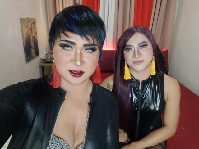 TwoLovelyPinayCums with short black hair and blue highlights, wearing a black leather top, showing cleavage. TwoLovelyPinayCums with purple hair, yellow tassels, black leather top, smiling.