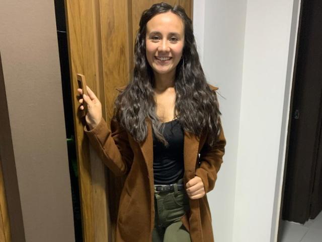 A minimalist illustration of a large, flat, stylized letter "L" in bold, dark brown with a light beige center. The letter has a smooth, solid texture.