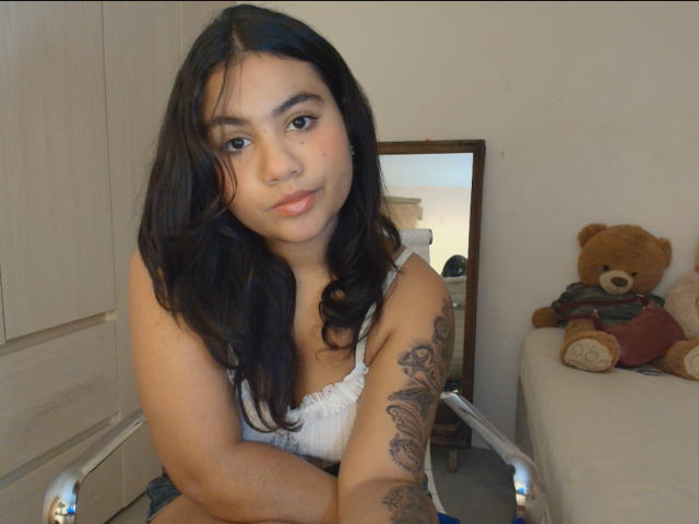 A flat, stylized coat of arms with bold, red and white colors. Large, overlapping letters form the design. Simple, symmetrical layout. Clean, minimalist style. White border.