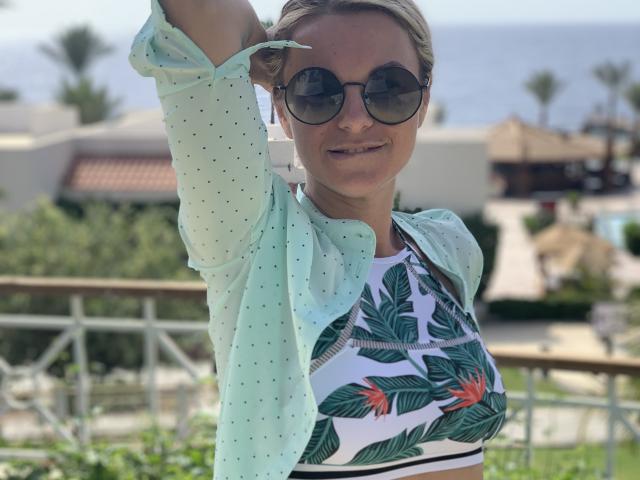 Digital art of a Japanese-style paper fan with a red and black design, centered in the frame. Soft, muted colors. Simple, clean lines. BelleLisaG is not present.