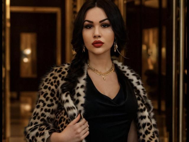 InkedFaye with leopard fur coat, black dress, red lipstick, gold necklace, and earrings, standing confidently, holding coat, wavy dark hair, serious expression, sexy, classy.
