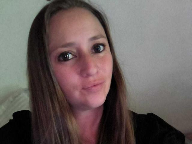 CelesteStorm has straight brown hair, large brown eyes, and a slight smile. She's wearing a black top, and her face is centered in the photo.