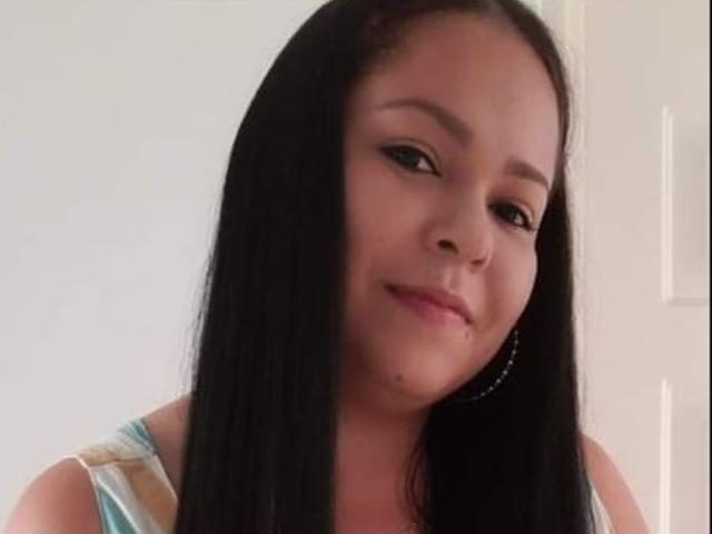 DulceHunny has long black hair, brown eyes, and a slight smile with a small pimple on her right cheek. She wears a sleeveless top and silver hoop earrings.