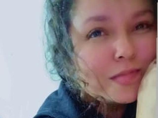 DulceHunny has curly brown hair, light skin, and a cute nose with a small boogers. She's looking at the camera with a slight smile, wearing a black shirt.