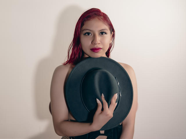 Flat, minimalist design of a red and black emblem with bold, geometric shapes. Central emblem features a small black dot in a red square. Clean, modern style.