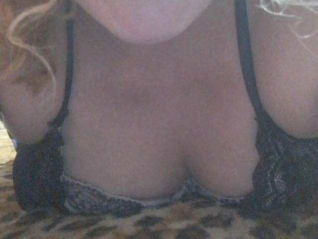 CrislimaJb's tits are showing in a black lace bra, with a leopard print fabric beneath her. Her blonde hair is partially visible.
