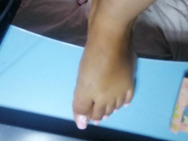 MariahSquirting69's foot is in the frame, showing a brown toe with pink nail polish, slightly blurred, against a blue and brown background.