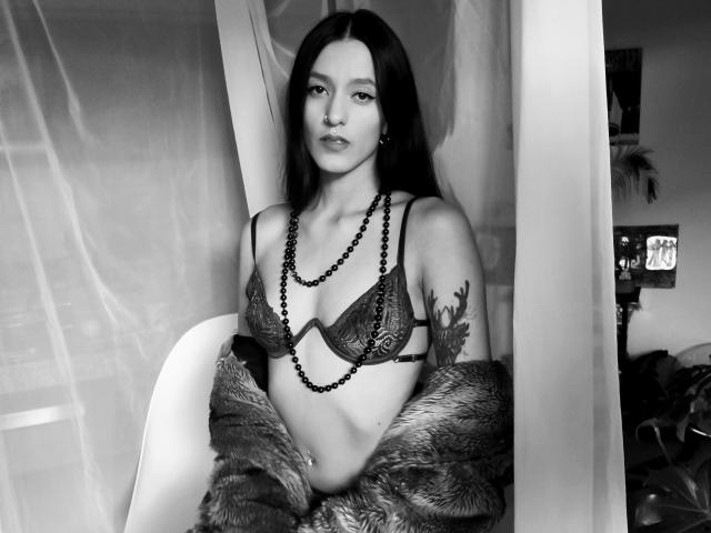 Minimalist style, flat colors. Large, central white letters with black dot pattern. Simple, clean design. No textures or gradients. Focuses on letter form and pattern. Flat, geometric composition.