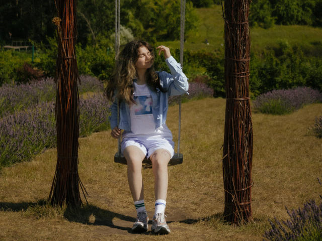 A flat, stylized coat of arms with a central white emblem on a blue background, flanked by brown. Simple, bold lines. TinaRedly not present. No additional textures or details.