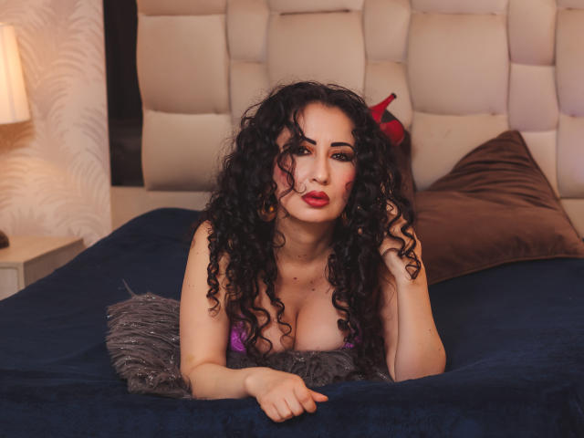 Flatter, minimalist style of a coat of arms. Soft, muted colors. Simple, symmetrical design. Central, bold red "V" on a beige background. Elegant, clean lines. No additional details.