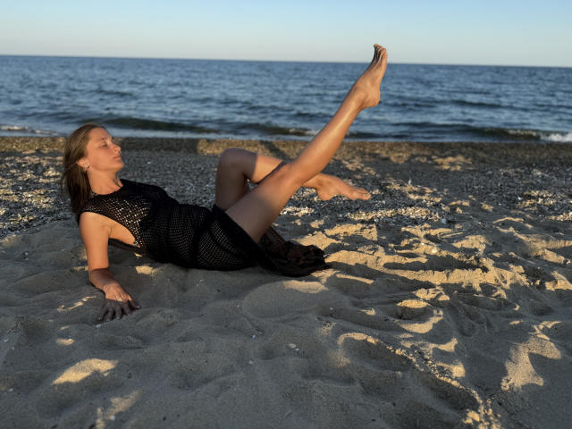 Digital art of a stylized, orange and black, medieval-style banner with a central, slightly curved, sword-like shape. Simple, bold lines and flat colors. Minimalistic, geometric design.