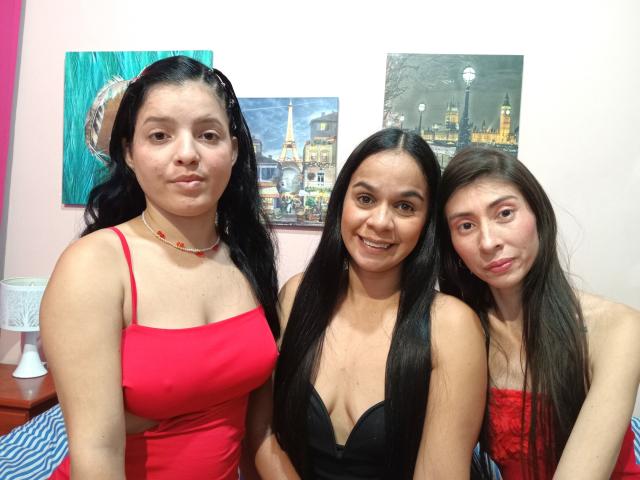 ThreeSensations with three women, one in a red tank top showing small tits, one in a black dress with large tits, and one in a red lace top.