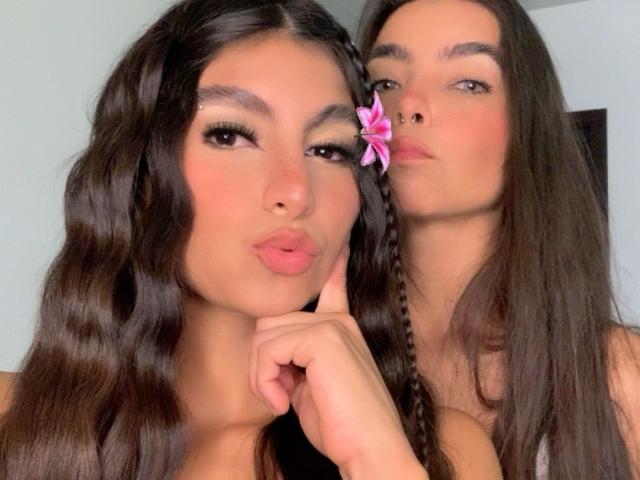MillyxNicollI with long dark hair, pouty lips, and a pink flower in her hair, next to MillyxNicollI with straight hair, nose piercing, and a subtle smile.