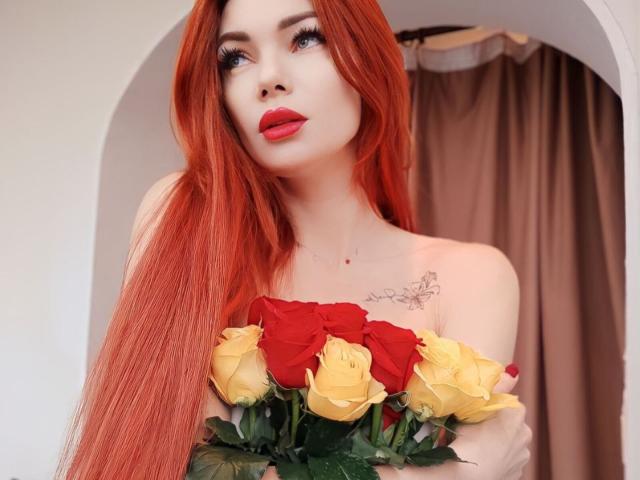 XRebeccaGlossX with long red hair, red lipstick, holding red and yellow roses, tattoos on chest, looking up with a slight smile, soft light, upper body, feminine, sexy.