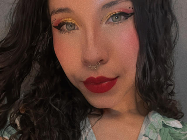 Three carved stone slabs with red paint in the center. Simple, flat design. Red paint forms a V-shape on each slab. Slabs positioned horizontally, evenly spaced. Minimalistic.
