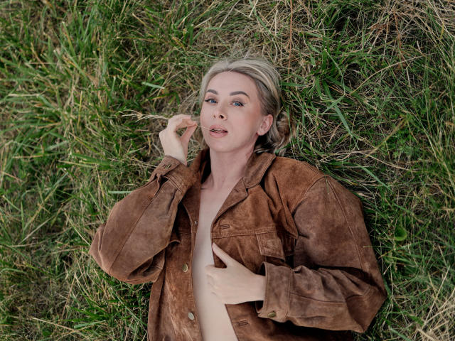 Digital artwork of a red Japanese-style paper fan with a subtle gradient, placed in the lower center. Background is minimal, with a green patterned design in the upper corners.