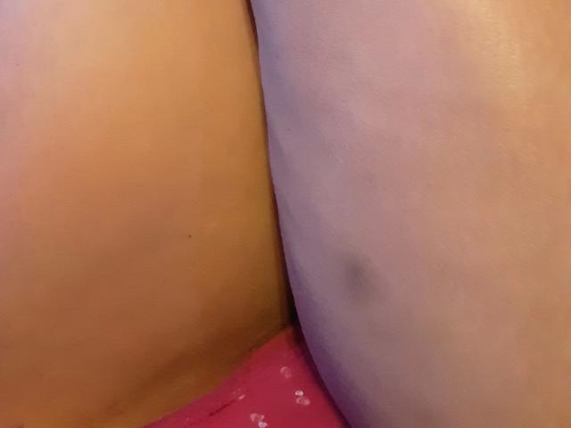 Sexybienchen93-hot's tan and pale skin butt cheeks are pressed together, showing a dark blue bruise on the pale side, with pink underwear visible at the bottom.