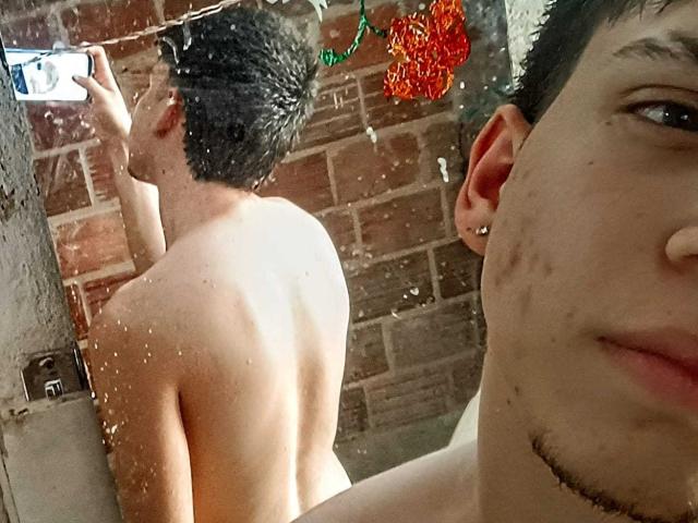 JonathanMoreau's back is to the camera, shirtless, with water droplets on his skin, holding a phone. JonathanMoreau's face is in the foreground, showing a slight smile.