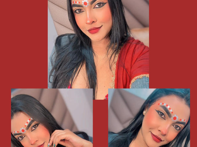 LakshmIrani has long black hair, red lipstick, and a decorative red and white dot pattern on her forehead. She's wearing a red and gold top, looking cute.