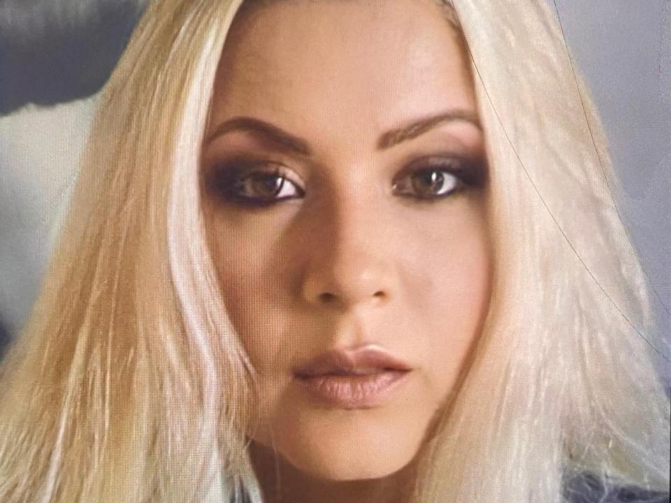 KarlaGodessTS has blonde hair, brown eyes, and full lips with a serious expression. Her makeup includes dark eyeliner and nude lipstick. Her ass is not visible.