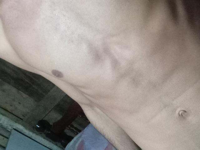 Morenhoh's bare, muscular torso with visible ribs, small nipple, and navel. Light skin, slight shadowing. Upper body, no clothes, focused on midsection.