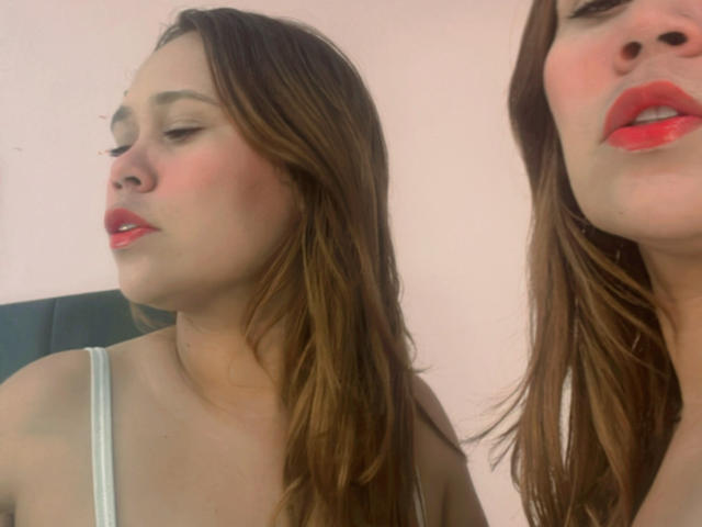 SophiaQueens has red lipstick, brown hair, and a slight pout, wearing a white top, showing her tits and soft ass in two side-by-side selfies.