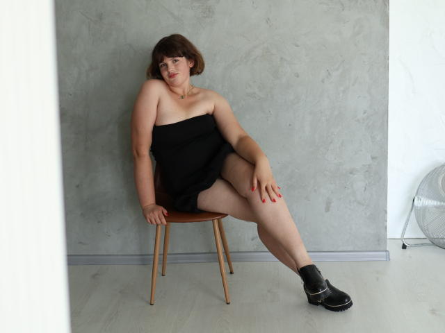 Digital illustration of a stylized, upright, red and white, modernist, minimalist, bold, geometric design with a central, slightly angled, red element and white background. Clean, sharp lines.