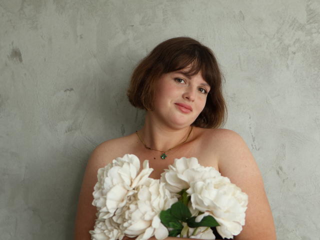 Close-up of a French flag, featuring red and white vertical stripes with a blue field in the upper left. Red flame-like symbol in the lower right. Simple, bold design.