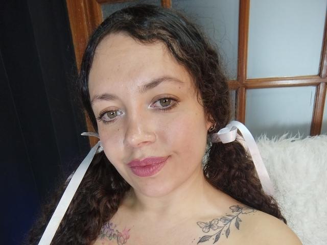 Digital illustration of a flat, minimalist coat of arms. Central, bold design with a small, red emblem in the bottom right. Soft, gradient colors. Simple, clean lines. RubbyStrongX not present.