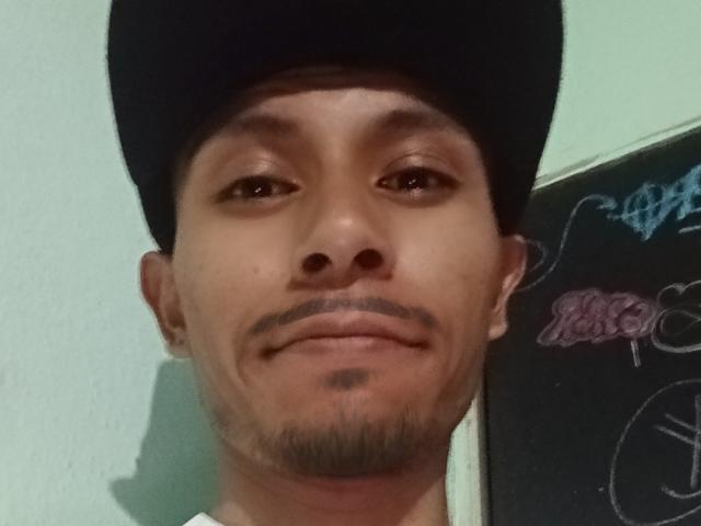 SiperoxXx4200, wearing a black cap, has a light brown face, small goatee, and a subtle smile. His eyes are brown, and he's looking slightly to the right.