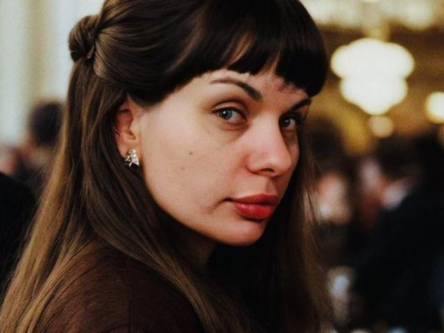 Black and white portrait of MalayaMe with straight dark hair, full eyebrows, and a serious expression, showing her pouty ass-kissing lips and slightly upturned nose.