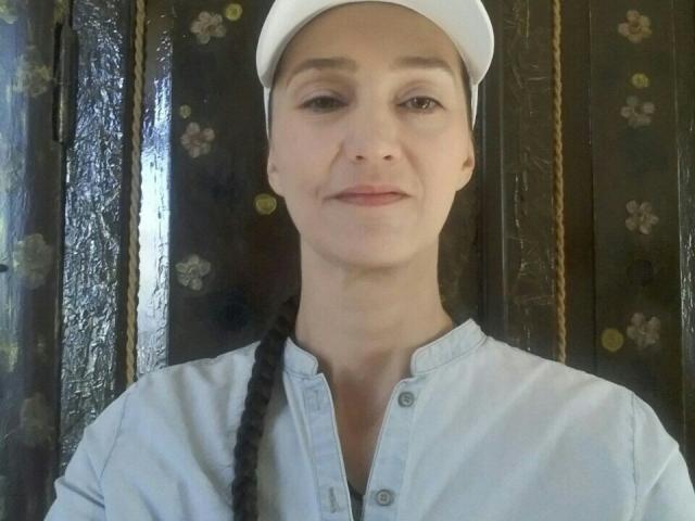 Flatter, stylized coat of arms with bold, dark letters in the top left corner. Center has a large, beige, shield-like emblem. Bottom features a smaller, white emblem. Clean, minimal design.