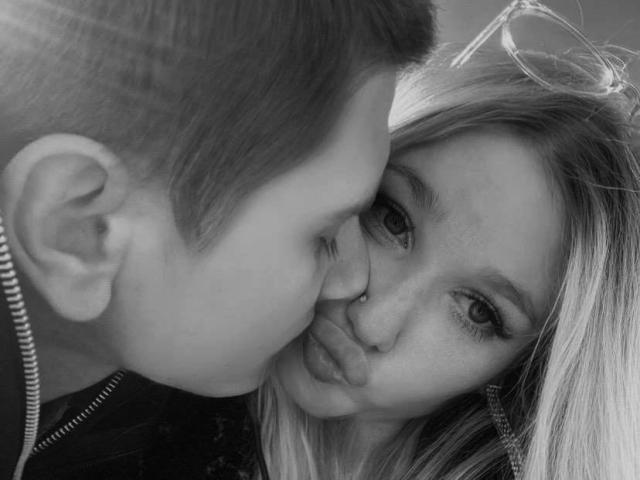 Primer plano de un escudo de armas minimalista y de estilo plano, con una "V" grande y llamativa en el centro. Alrededor de la "V" hay cuatro formas de "V" más pequeñas. Los colores son apagados..