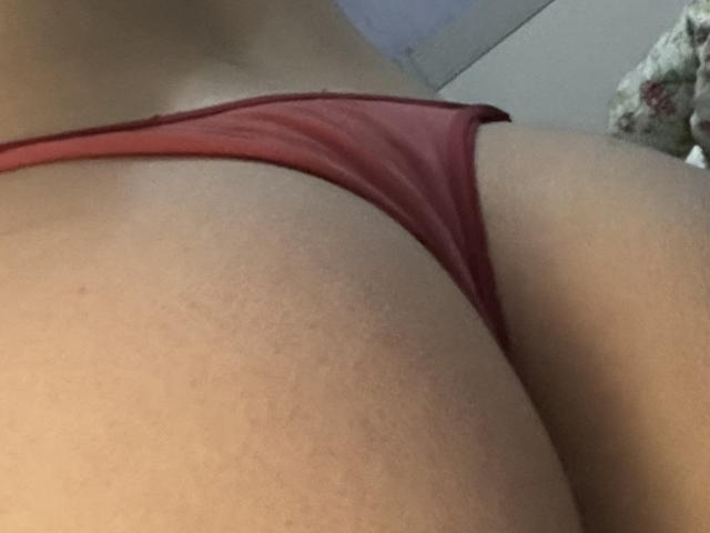 Sol69's butt in red underwear, showing their tan skin and the side of their bare buttcheek. The focus is on the right buttcheek and red thong.