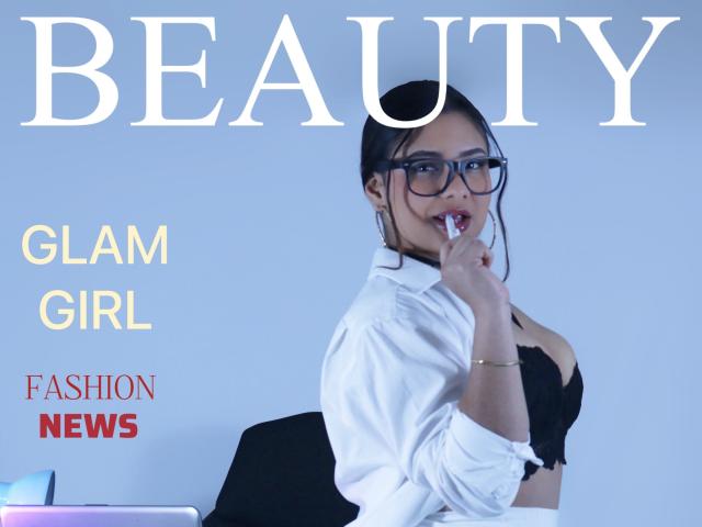 OrianaGarciax with glasses, white shirt, black bra, finger in mouth, showing big tits, black hair in bun, blue background, looking sexy. Glam girl, fashion news.