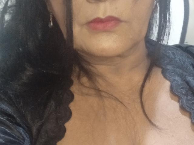 ZoeGuadalupe's face, focusing on her red lips, slightly visible chin, and black lace-trimmed top, showing her cleavage and some skin texture. Her black hair is partially in frame.